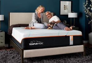 A couple laying on a tempur-pedic mattress