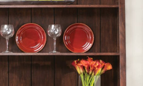 A cabinet with flowers, plates, and glasses