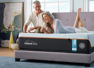 couple laying on a tempur-pedic memory foam mattress