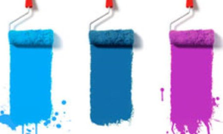 Three paint rollers with different color paint on each