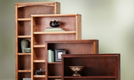 Four bookcases of different sizes and wood types