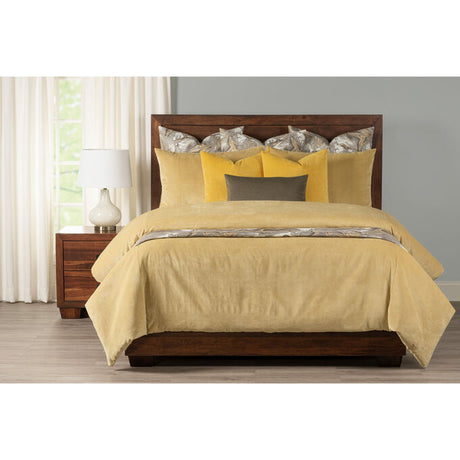 Yellow comforter on bed