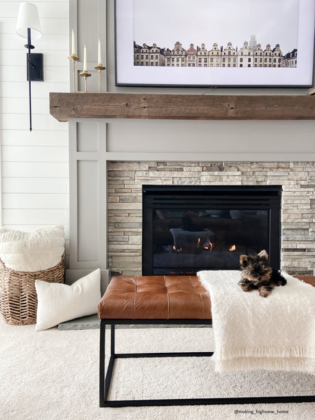 Living room with bench, lamp, candlesticks, and wall art