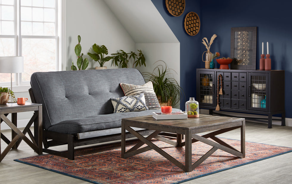 Futon and coffee table in decorated room