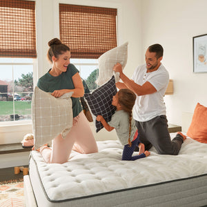 Family playing on Sealy Posturepedic Spring Bloom Medium Mattress