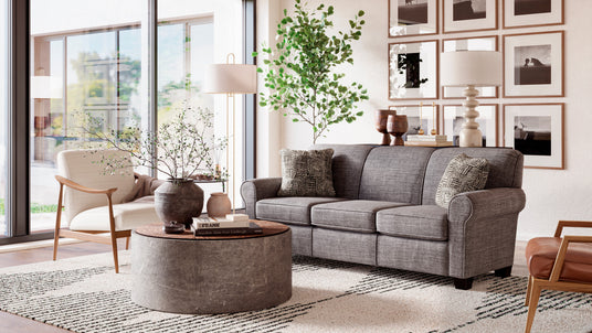 Living room with coffee table, sofa, and accent chairs