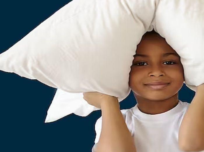 Child holding a pillow on top of their head