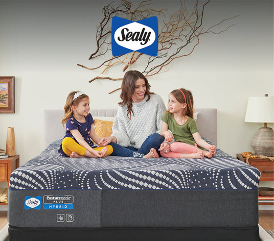 Mother and children on Sealy Posturepedic Plus Hybrid mattress