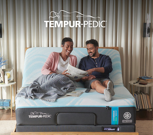 Couple laying on Lux Breeze Hybrid mattress