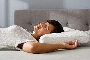 Woman laying on pillow happily